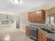 Modern kitchen featuring tile floors, granite counters, and stainless steel dishwasher at 124 Williams Blf, Mcdonough, GA 30252