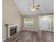 Bright living room featuring vaulted ceilings, a fireplace, and wood-look flooring at 124 Williams Blf, Mcdonough, GA 30252