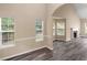 Inviting living space with large windows, neutral paint, and wood-look floors at 124 Williams Blf, Mcdonough, GA 30252