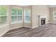 Sunlit living area with windows, modern flooring, and a cozy fireplace at 124 Williams Blf, Mcdonough, GA 30252