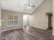 Bright living room with fireplace, vaulted ceiling, ceiling fan, and hardwood floors at 124 Williams Blf, Mcdonough, GA 30252