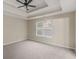 Spacious main bedroom with carpet, tray ceiling, and a ceiling fan at 124 Williams Blf, Mcdonough, GA 30252