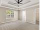 Spacious main bedroom with tray ceilings, ceiling fan, carpet and lots of natural light at 124 Williams Blf, Mcdonough, GA 30252
