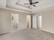 Large main bedroom with tray ceiling, ceiling fan, carpet, and en suite bathroom at 124 Williams Blf, Mcdonough, GA 30252