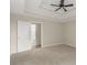 Main bedroom features tray ceilings, carpet and an en suite bathroom at 124 Williams Blf, Mcdonough, GA 30252