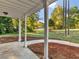 Covered patio space with a concrete floor and a large front yard and landscaping at 124 Williams Blf, Mcdonough, GA 30252