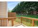 Wooden back deck overlooking a lush green hillside lined with mature trees, providing a private outdoor space at 2419 Ivey Crest Cir, Tucker, GA 30084
