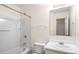 Bright bathroom featuring a tub shower combo, white vanity, and framed mirror at 2419 Ivey Crest Cir, Tucker, GA 30084