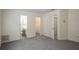 Carpeted bedroom with view into bathroom and closet with open doors to other rooms at 2419 Ivey Crest Cir, Tucker, GA 30084