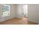 Cozy bedroom with hardwood floors and a large window providing natural light, with an attached bathroom at 2419 Ivey Crest Cir, Tucker, GA 30084