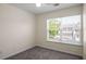 Bright bedroom featuring neutral walls, plush carpeting, and a window with neighborhood views at 2419 Ivey Crest Cir, Tucker, GA 30084