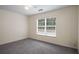 Bright bedroom featuring neutral walls, plush carpeting, and a window with tree views at 2419 Ivey Crest Cir, Tucker, GA 30084
