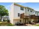 The backyard view of this traditional townhome has a wooden deck and grassy lawn at 2419 Ivey Crest Cir, Tucker, GA 30084
