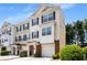 Inviting three-story townhome showcasing a charming exterior with a one-car garage and well-maintained landscaping at 2419 Ivey Crest Cir, Tucker, GA 30084