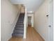 This home's hallway features a staircase with carpet and sleek hardwood floors at 2419 Ivey Crest Cir, Tucker, GA 30084