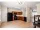 Well-lit kitchen featuring wood cabinetry, black appliances, and durable countertops, with adjacent living area access at 2419 Ivey Crest Cir, Tucker, GA 30084