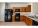 Modern kitchen showcasing wood cabinets, black appliances, and laminate countertops, designed for efficiency and style at 2419 Ivey Crest Cir, Tucker, GA 30084