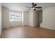 Bright living room featuring hardwood floors, a modern ceiling fan, and a large window offering plenty of natural light at 2419 Ivey Crest Cir, Tucker, GA 30084