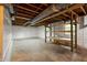 Spacious unfinished basement with exposed beams, concrete floor, and built-in shelving at 4228 Durham Cir, Stone Mountain, GA 30083