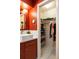 Stylish bathroom with a white vessel sink, gold fixtures, and a walk-in closet for extra storage at 4228 Durham Cir, Stone Mountain, GA 30083