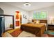 Bright bedroom featuring modern decor, ensuite bathroom, natural light, and a colorful accent rug at 4228 Durham Cir, Stone Mountain, GA 30083