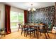 Bright dining room with decorative wallpaper, natural light, and seating for six at 4228 Durham Cir, Stone Mountain, GA 30083