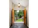 Inviting entryway with stone floors, stylish light fixture, and open view to the beautifully landscaped front yard at 4228 Durham Cir, Stone Mountain, GA 30083