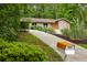 Charming home featuring a stone facade, updated windows, and an eye-catching orange mailbox for added curb appeal at 4228 Durham Cir, Stone Mountain, GA 30083
