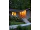 Inviting home exterior with stone facade, illuminated entryway, and beautifully landscaped yard at 4228 Durham Cir, Stone Mountain, GA 30083