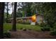 Well-manicured front lawn and stone facade highlight this charming home nestled among mature trees at 4228 Durham Cir, Stone Mountain, GA 30083