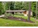 Charming home with updated windows, a landscaped yard, bright orange front door, and a convenient carport at 4228 Durham Cir, Stone Mountain, GA 30083