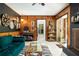 Spacious living room with wood paneling, record player, and access to the kitchen and outdoor spaces at 4228 Durham Cir, Stone Mountain, GA 30083