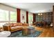 Spacious living room with large windows, hardwood floors, leather sofa, and ornate wallpaper at 4228 Durham Cir, Stone Mountain, GA 30083