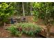 Private outdoor area features a wooden deck with bistro seating surrounded by lush greenery at 4228 Durham Cir, Stone Mountain, GA 30083