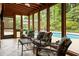Relaxing patio with outdoor furniture, ceiling fan, views of the backyard pool and natural light throughout at 4228 Durham Cir, Stone Mountain, GA 30083