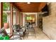 Cozy patio with comfortable seating, ceiling fan, stone wall and access to the interior through sliding glass doors at 4228 Durham Cir, Stone Mountain, GA 30083