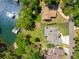 Aerial view of a lakeside property with docks, boats, and mature trees at 5635 Cherokee Trce, Cumming, GA 30041