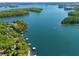 Aerial view showcasing a lakefront property surrounded by lush greenery at 5635 Cherokee Trce, Cumming, GA 30041