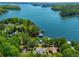 This aerial view showcases a lakefront home with private dock access and lush, green surroundings at 5635 Cherokee Trce, Cumming, GA 30041