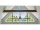 Striking architectural detail featuring triangular windows providing serene outdoor views and a ceiling fan at 5635 Cherokee Trce, Cumming, GA 30041