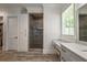 Spacious bathroom with dual vanity, makeup area, and glass-enclosed shower with tiled walls at 5635 Cherokee Trce, Cumming, GA 30041