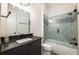 Well-lit bathroom with glass-enclosed shower, dark vanity, and modern fixtures at 5635 Cherokee Trce, Cumming, GA 30041