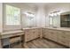 Bathroom featuring double vanities, marble countertops, ample cabinet space, and modern lighting fixtures at 5635 Cherokee Trce, Cumming, GA 30041