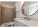 Beautiful bathroom features a vanity, decorative tile shower, and modern fixtures at 5635 Cherokee Trce, Cumming, GA 30041
