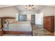 Relaxing bedroom featuring hardwood floors, neutral paint, and a view of the outdoors at 5635 Cherokee Trce, Cumming, GA 30041