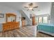 Spacious bedroom featuring hardwood floors, a ceiling fan, and plenty of natural light at 5635 Cherokee Trce, Cumming, GA 30041