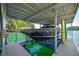 Covered boat lift with a boat securely in place, ready for a day on the water, with colorful kayaks nearby at 5635 Cherokee Trce, Cumming, GA 30041