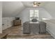Bonus room featuring wood-look floors, ceiling fan, and a large desk perfect for a home office at 5635 Cherokee Trce, Cumming, GA 30041
