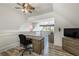 Bonus room with wood-look floors, a ceiling fan, a desk, and plenty of natural light at 5635 Cherokee Trce, Cumming, GA 30041