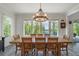 Dining area with a wood table, chandelier, and view of the lake at 5635 Cherokee Trce, Cumming, GA 30041